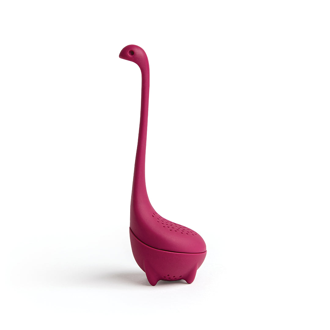 The pink Baby Nessie tea infuser by OTOTO features a long neck and small feet, allowing it to stand upright.