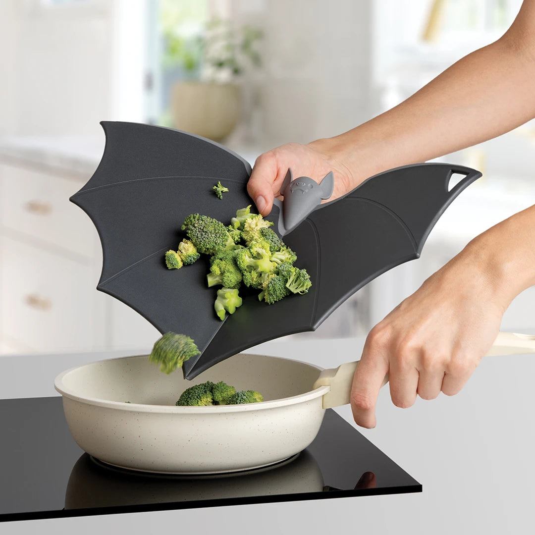 Batty, the bat-shaped board by OTOTO, aids in gracefully transferring broccoli to the pan.