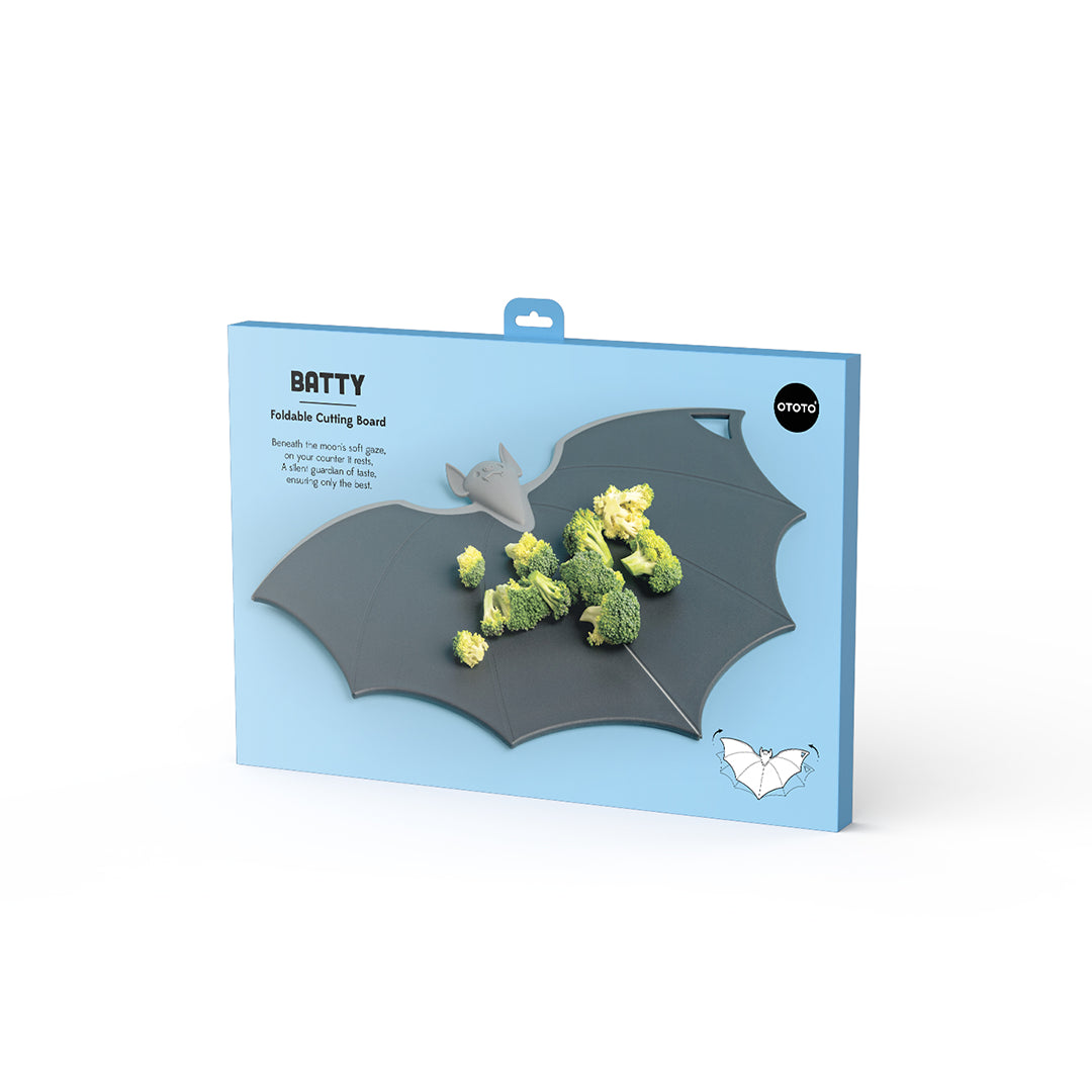 A Batty board with folding wings and broccoli pieces; packaged in blue.