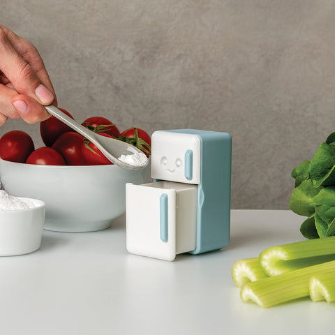 The Cool Guy, a cute fridge-shaped container with a smiling face, is a perfect fridge deodorizer for veggies.