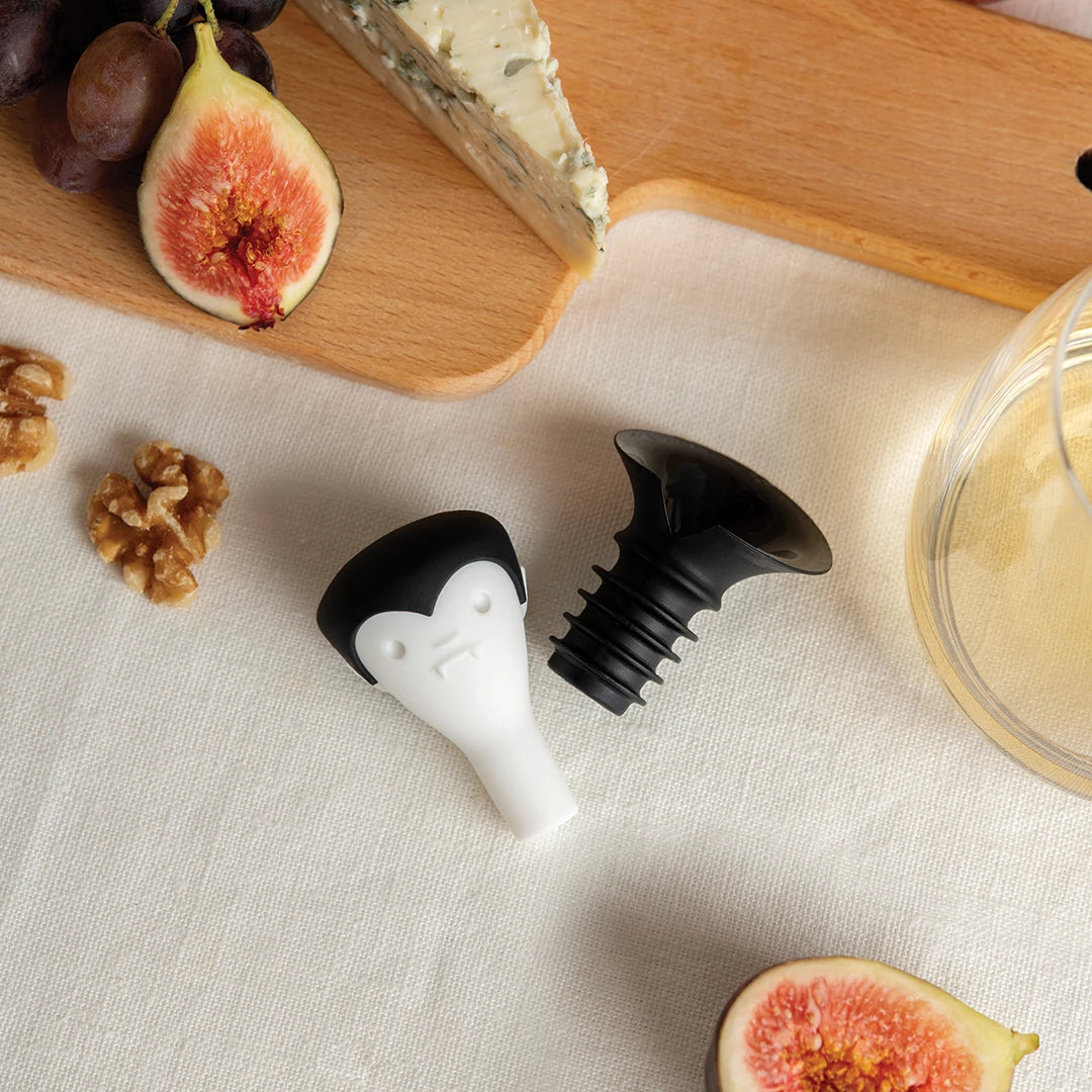 Count Corkula on the table surrounded by figs, walnuts, cheese, and grapes.