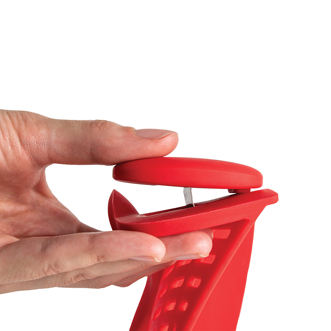 Hand holding Crabby, an OTOTO red plastic bag sealer with a clasp and grip, a handy kitchen accessory.