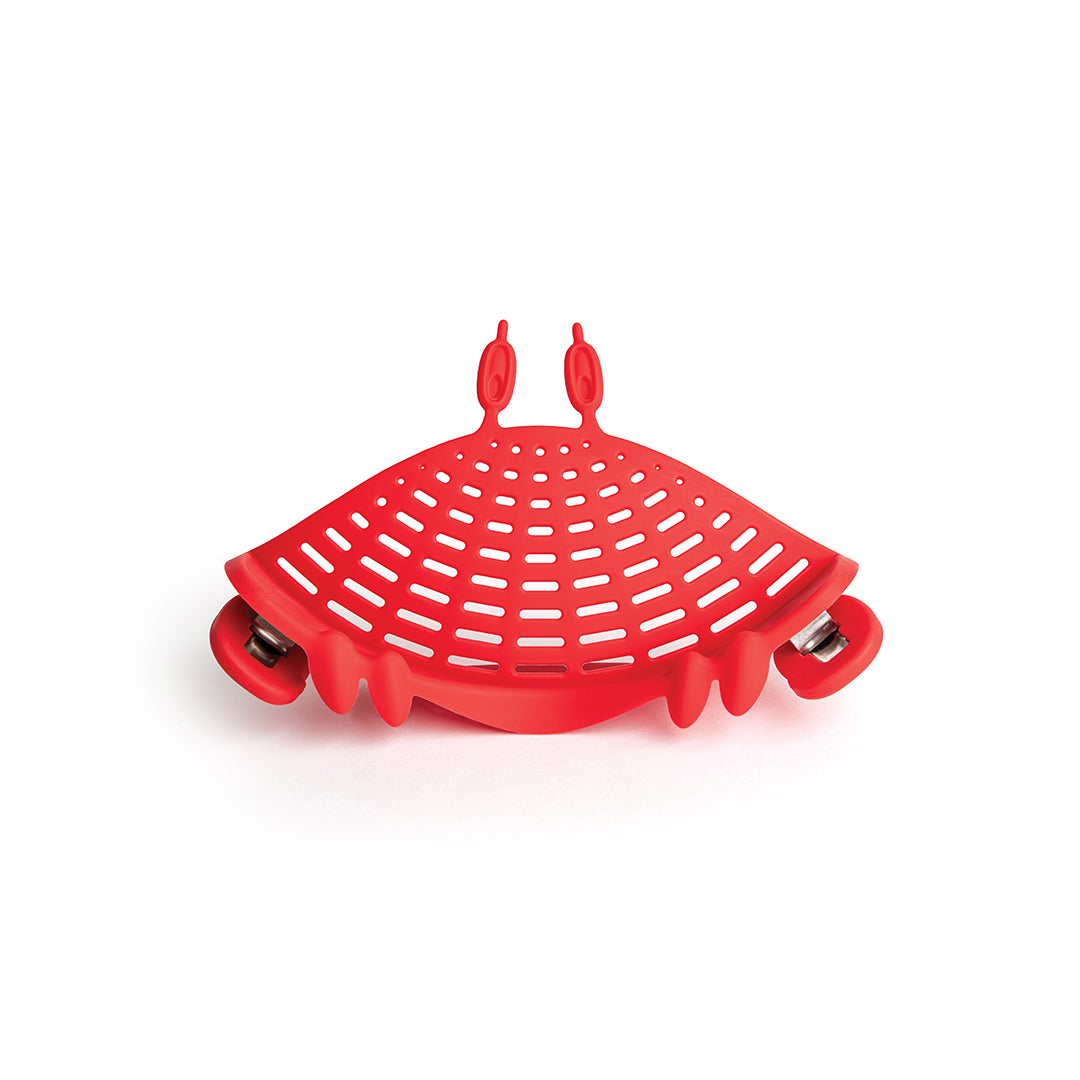 The OTOTO Crabby red silicone strainer clips onto pots with handles and hooks—a perfect kitchen accessory.