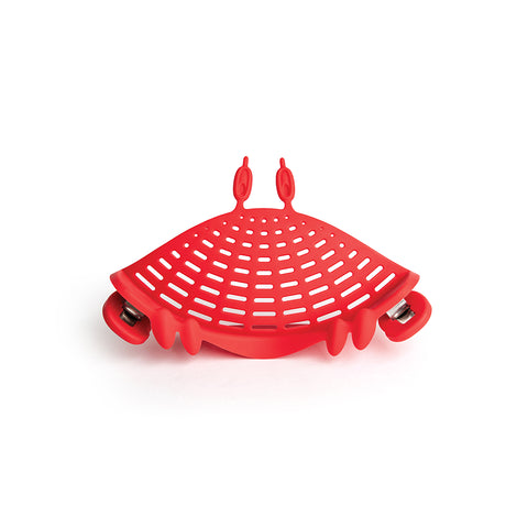 The OTOTO Crabby red silicone strainer clips onto pots with handles and hooks—a perfect kitchen accessory.