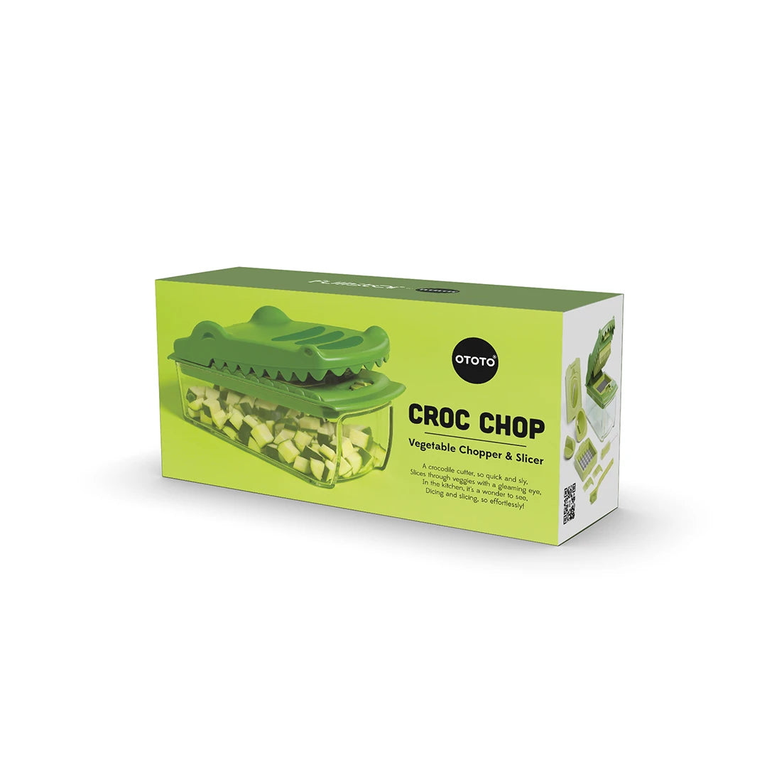 Box of Croc Chop food chopper with a green alligator lid and interchangeable blades.