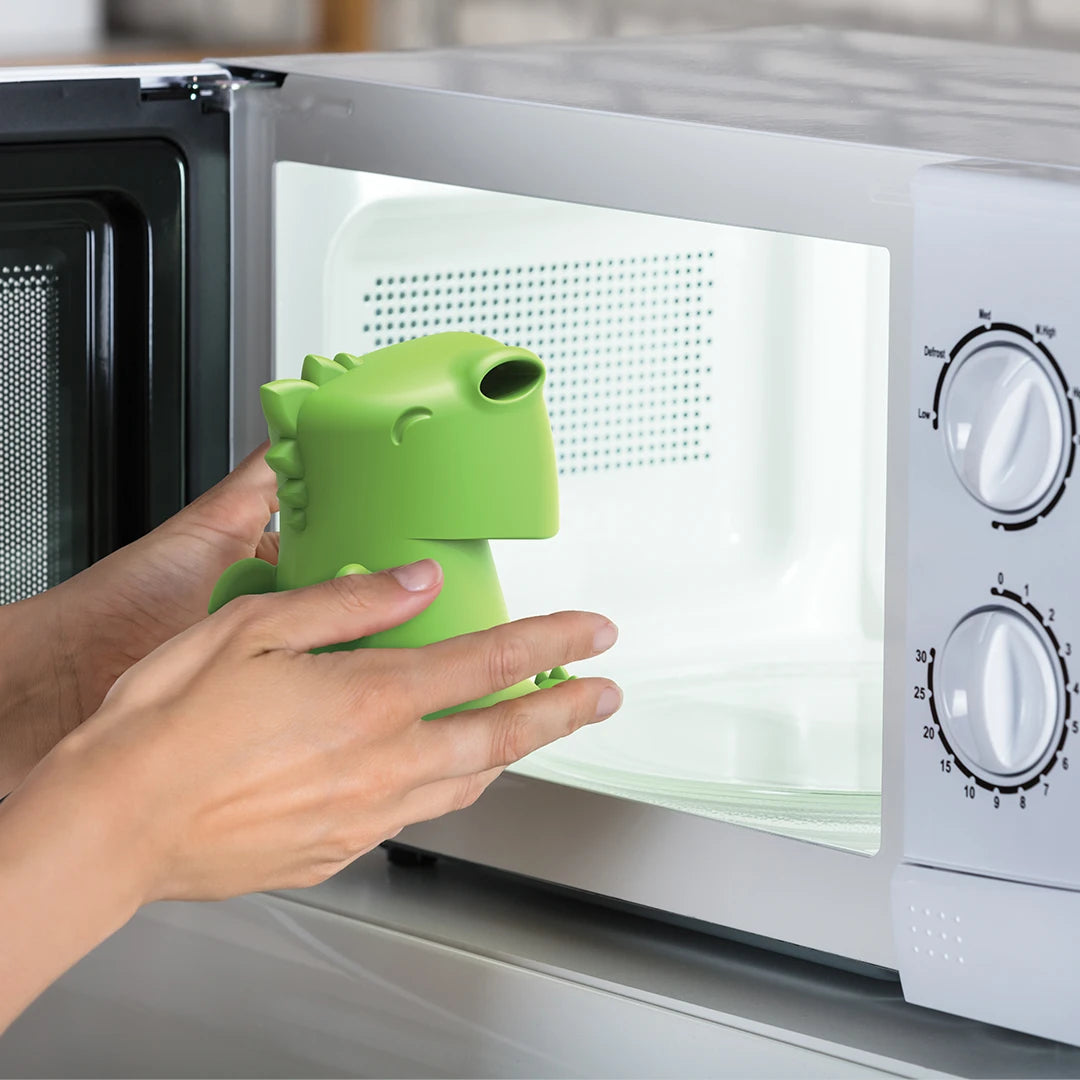 Placing a green Dracowave by OTOTO into the microwave.