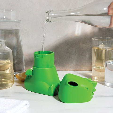 OTOTOs Dracowave humidifier, a green dinosaur shape, being filled on a bathroom counter.