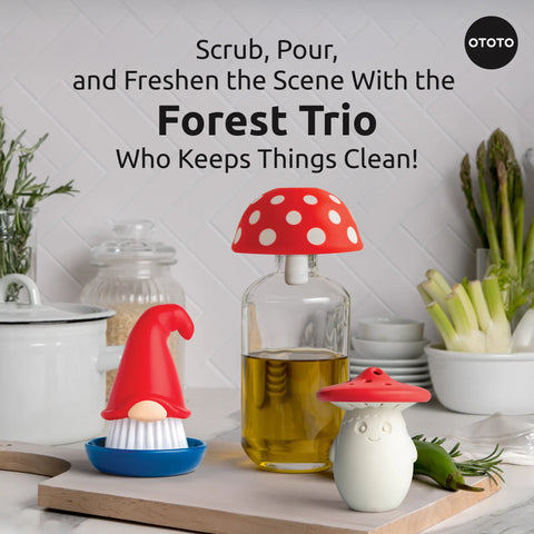 The Forest Trio—gnome, mushroom fridge deodorizer, and bottle brush—sits on a kitchen counter.