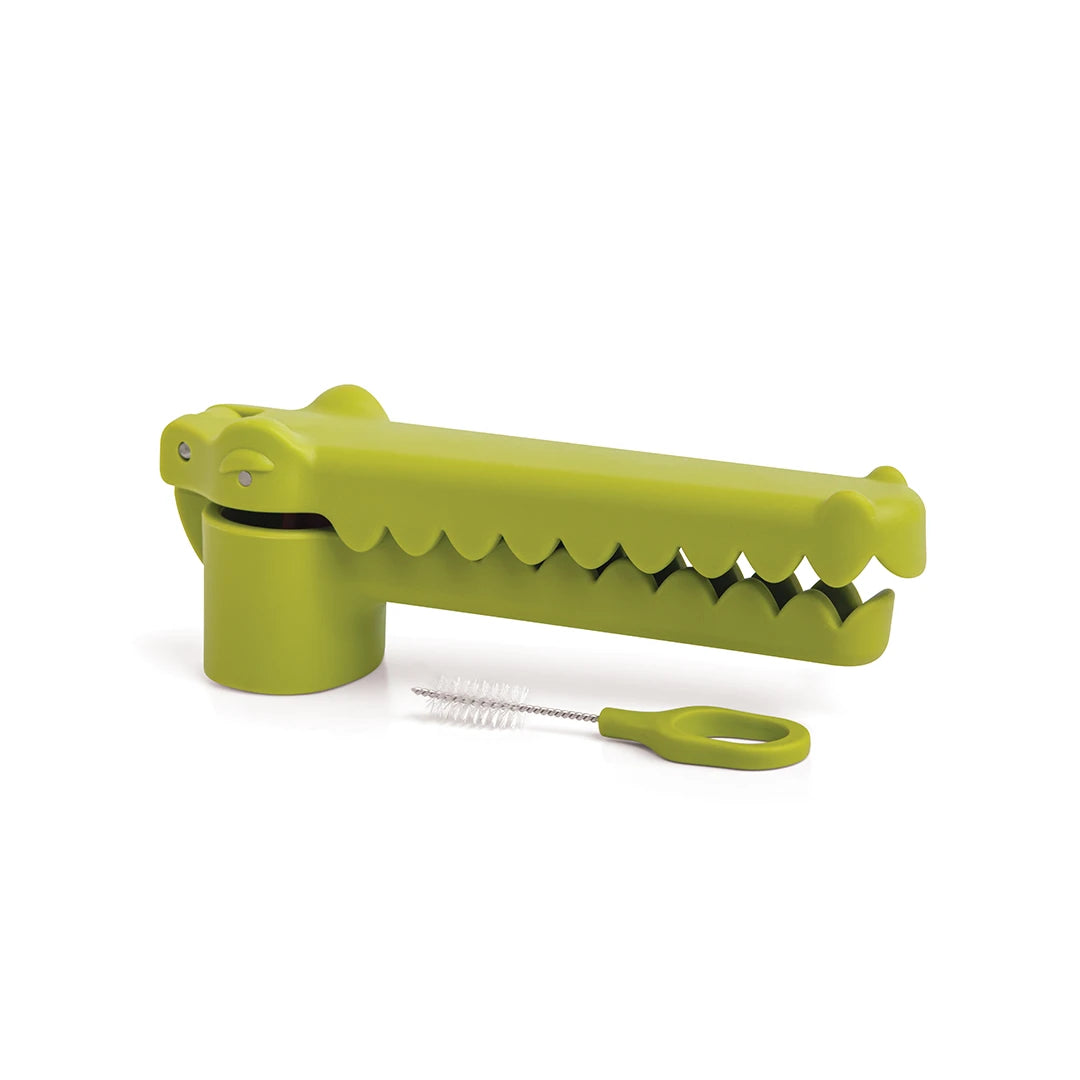 OTOTOs Garligator garlic press, shaped like a green crocodile, comes with a cleaning brush.