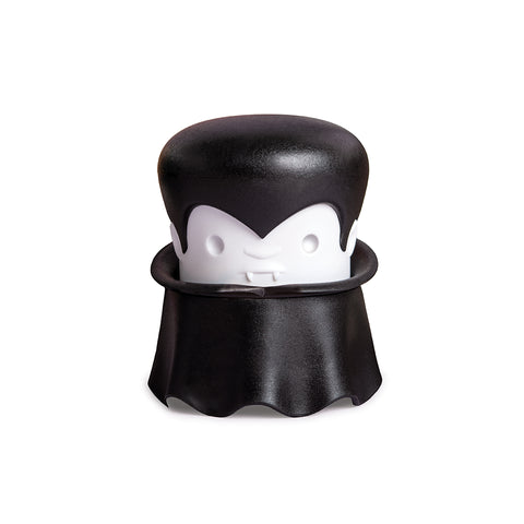A cartoon vampire with a cape and fangs holds an OTOTO Gracula garlic crusher.