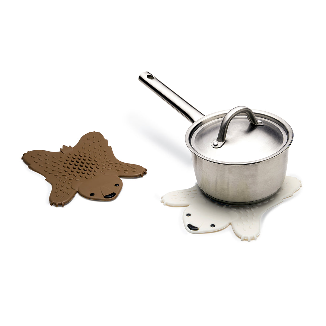 Saucepan on Lilach Eytans white bear trivet beside a Grizzly trivet.