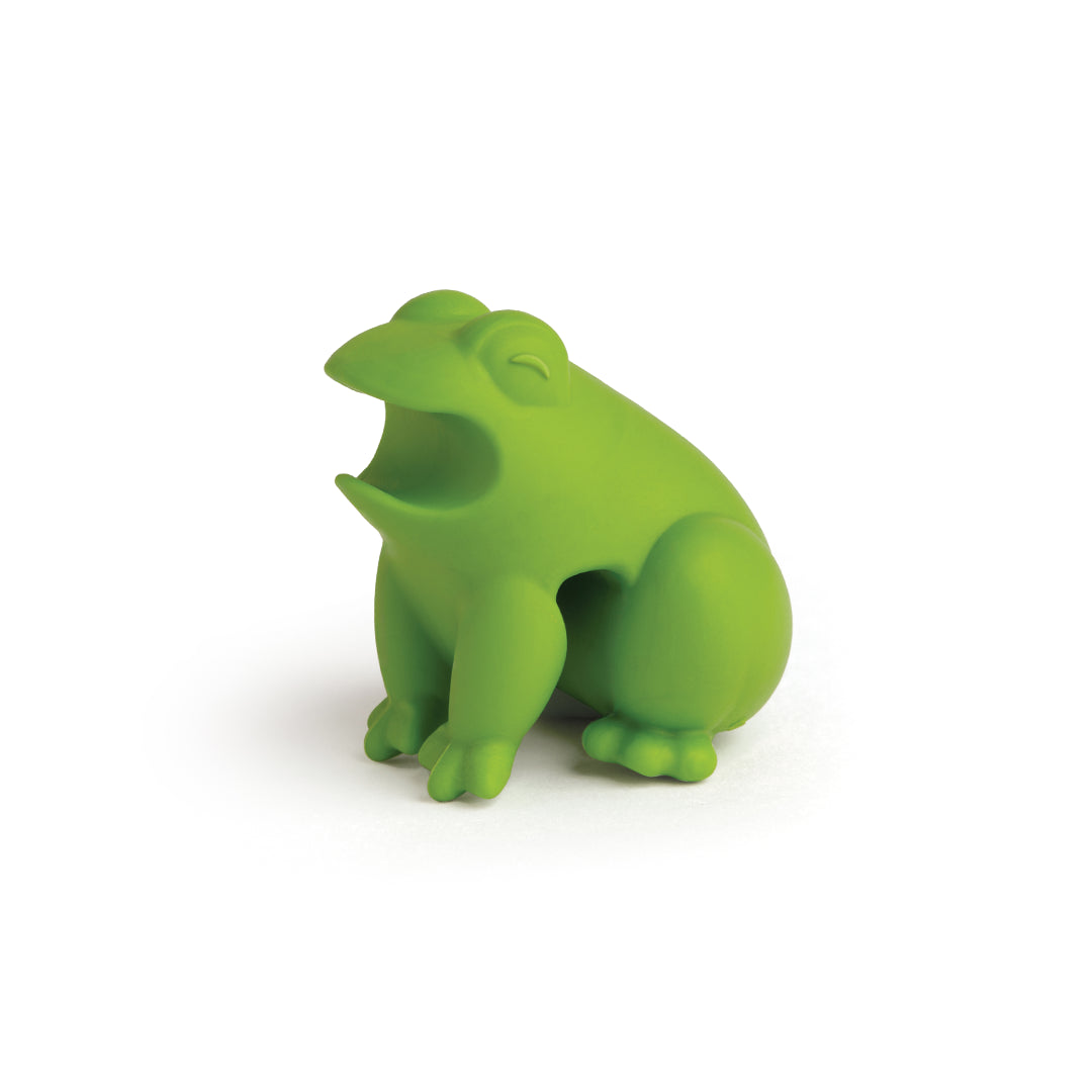 A HopTop, green froggy spoon rest with open mouth, toy-shaped on a white background.