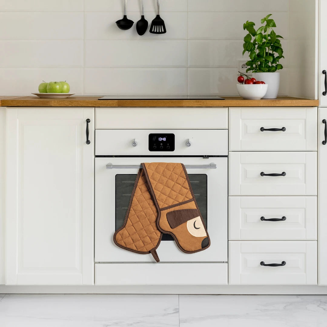 Modern kitchen with a white oven, Hot-dog Mitts, and a plant on the counter.