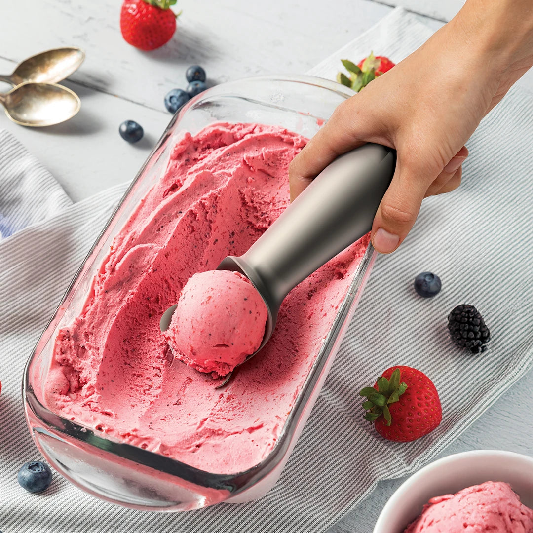 Scooping ice cream with the Big Dipper Ice Cream Scoop by OTOTO, served with berries and spoons.