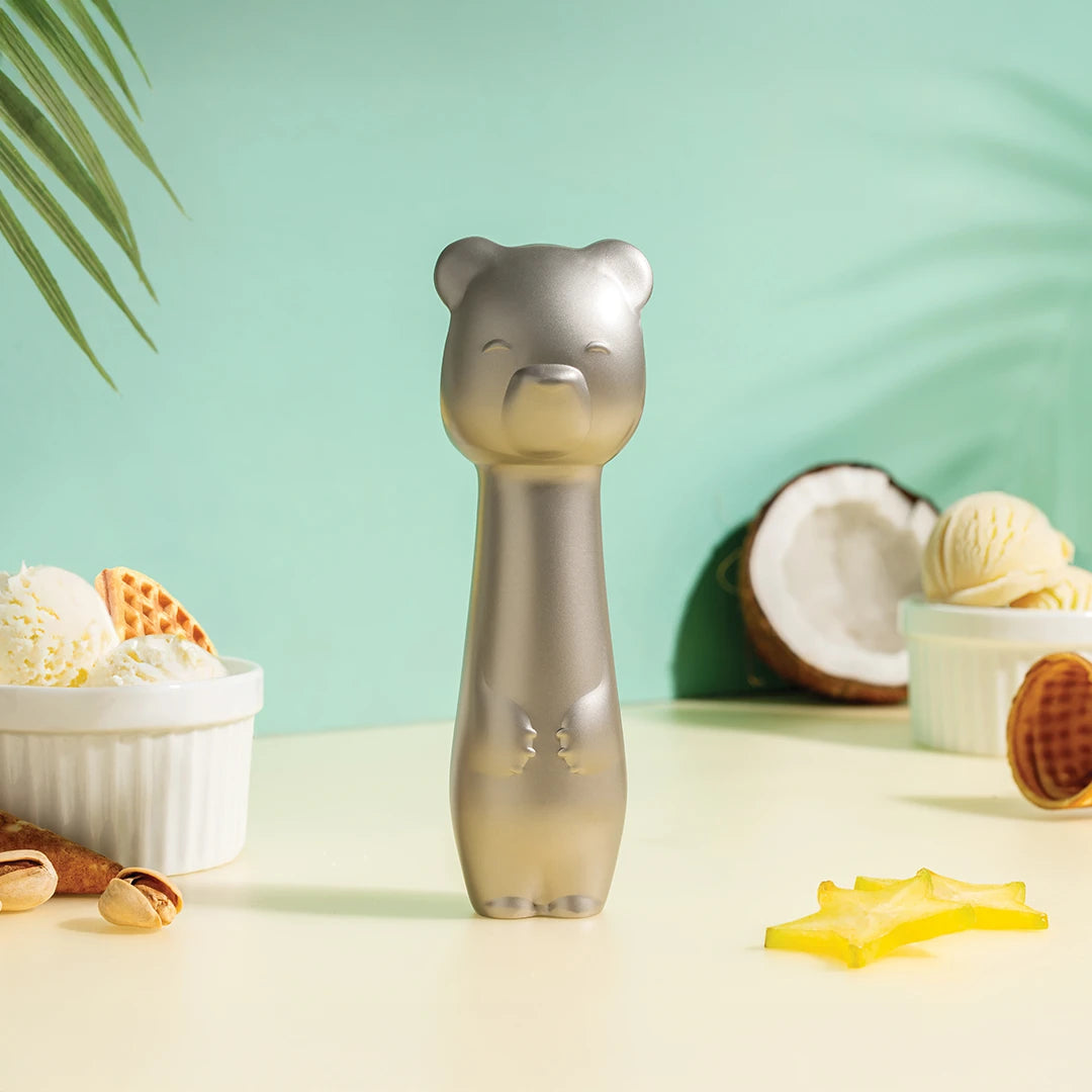 Big Dipper Ice Cream Scoop, a silver bear by OTOTO, sits on pastel with tropical fruits and waffles.