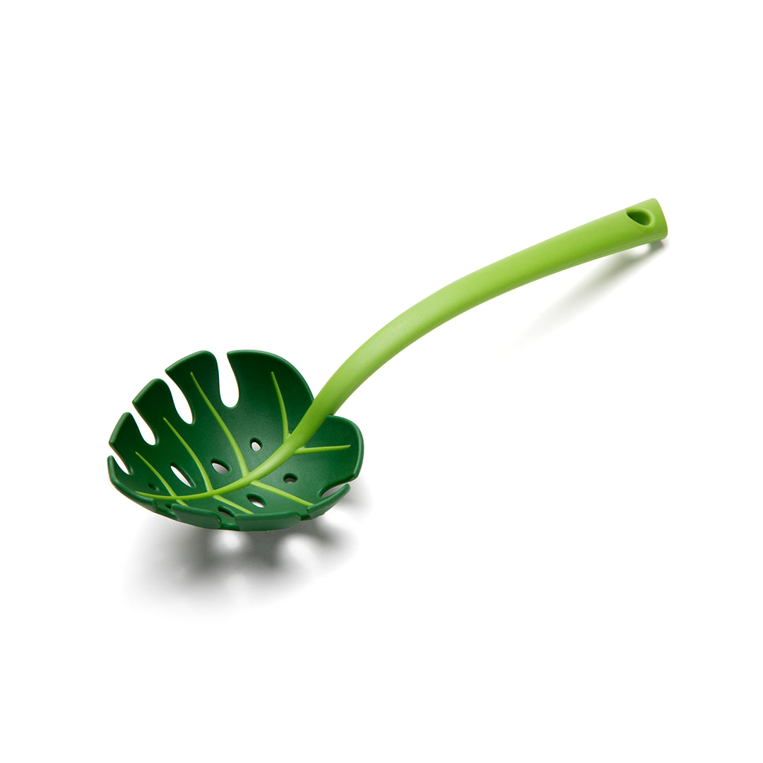 Jungle Spoon: Green leaf-shaped slotted spoon with a long handle on a white background.
