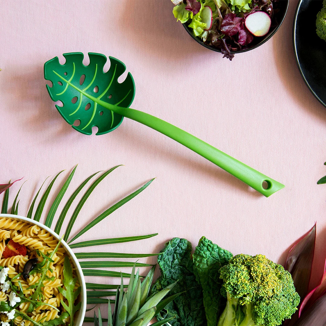 The Jungle Spoon blends perfectly with salads and pasta in its leaf-shaped design on the table.