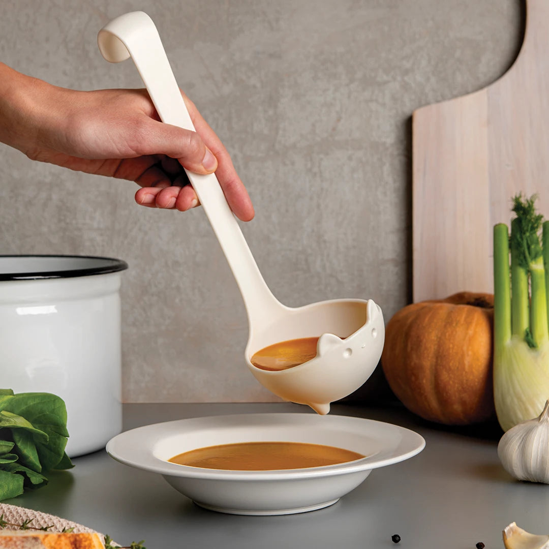 In her cozy kitchen, Katie uses her trusty OTOTO ladle to pour soup into a bowl.