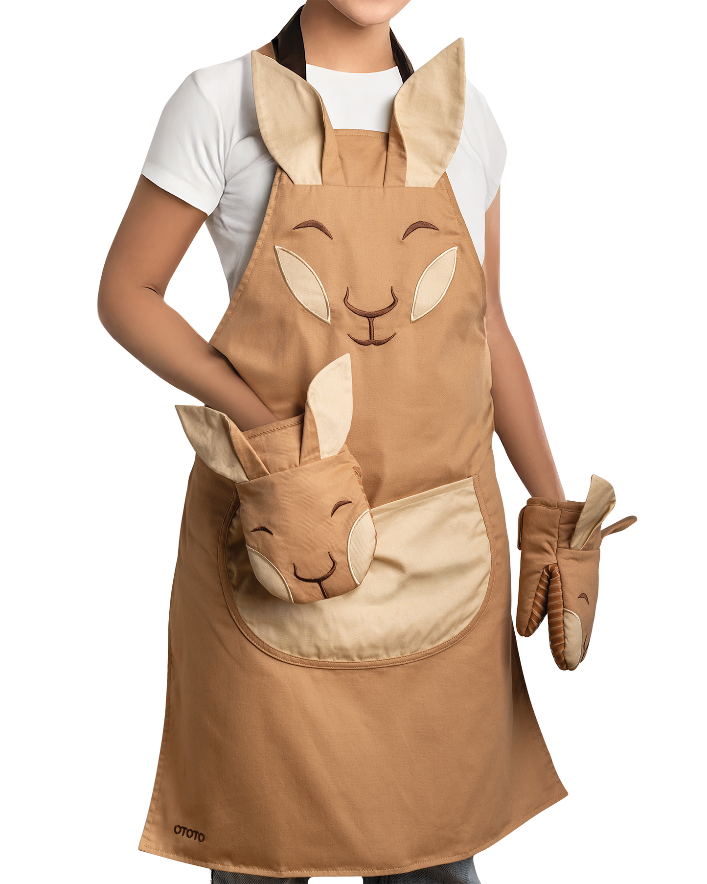 Someone wears the Aproo apron and oven mitts, both decorated with cute bunny faces and ears.