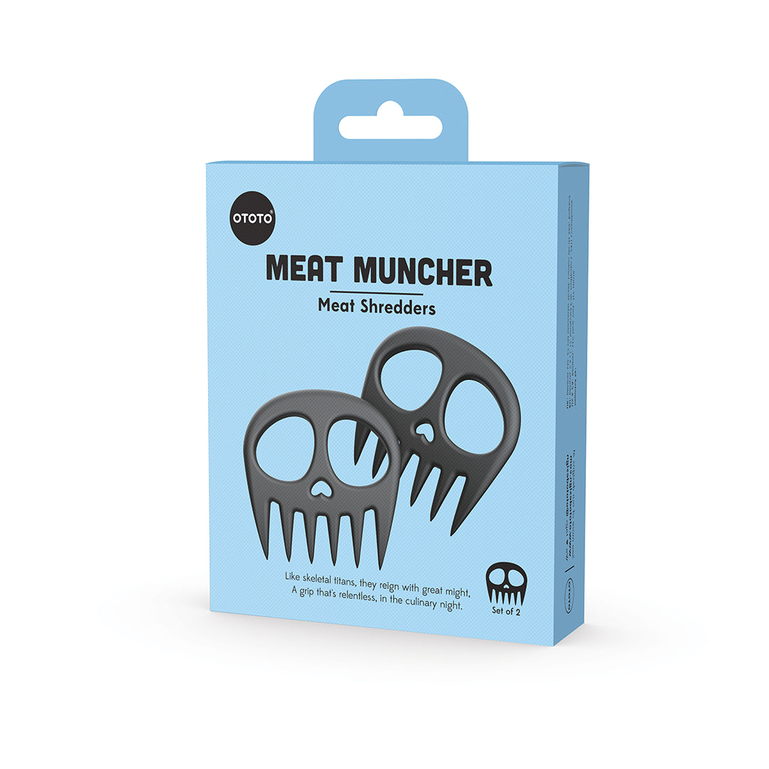 OTOTO Meat Muncher: Shred meat with this skull-shaped tool, packaged in a blue box with its image.