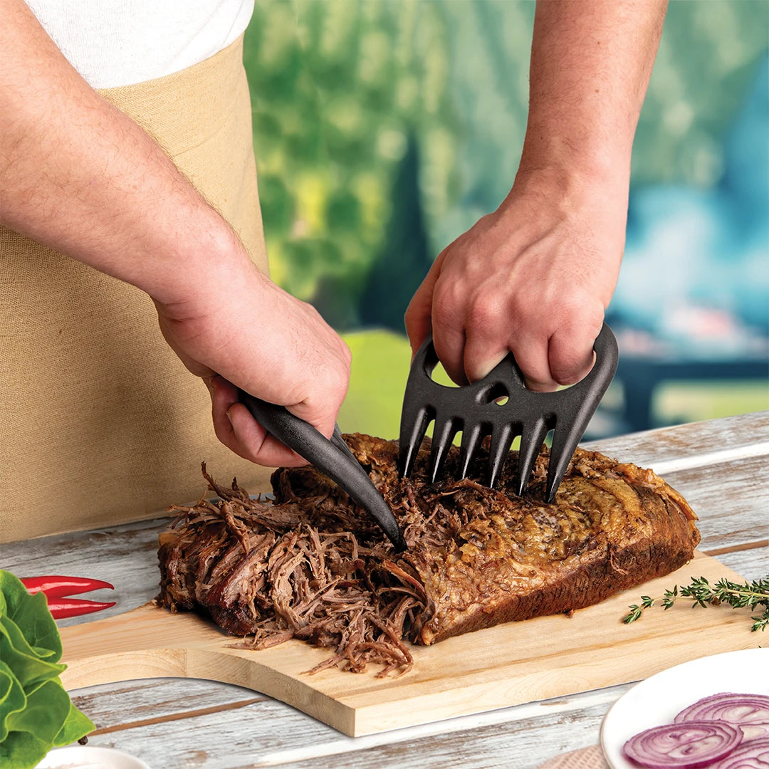OTOTOs Meat Muncher shreds cooked meat on outdoor wooden boards.