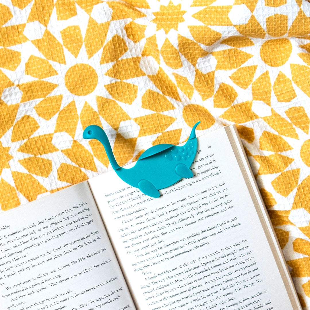 Open your book with Nessie Tale on a yellow and white floral-patterned surface.