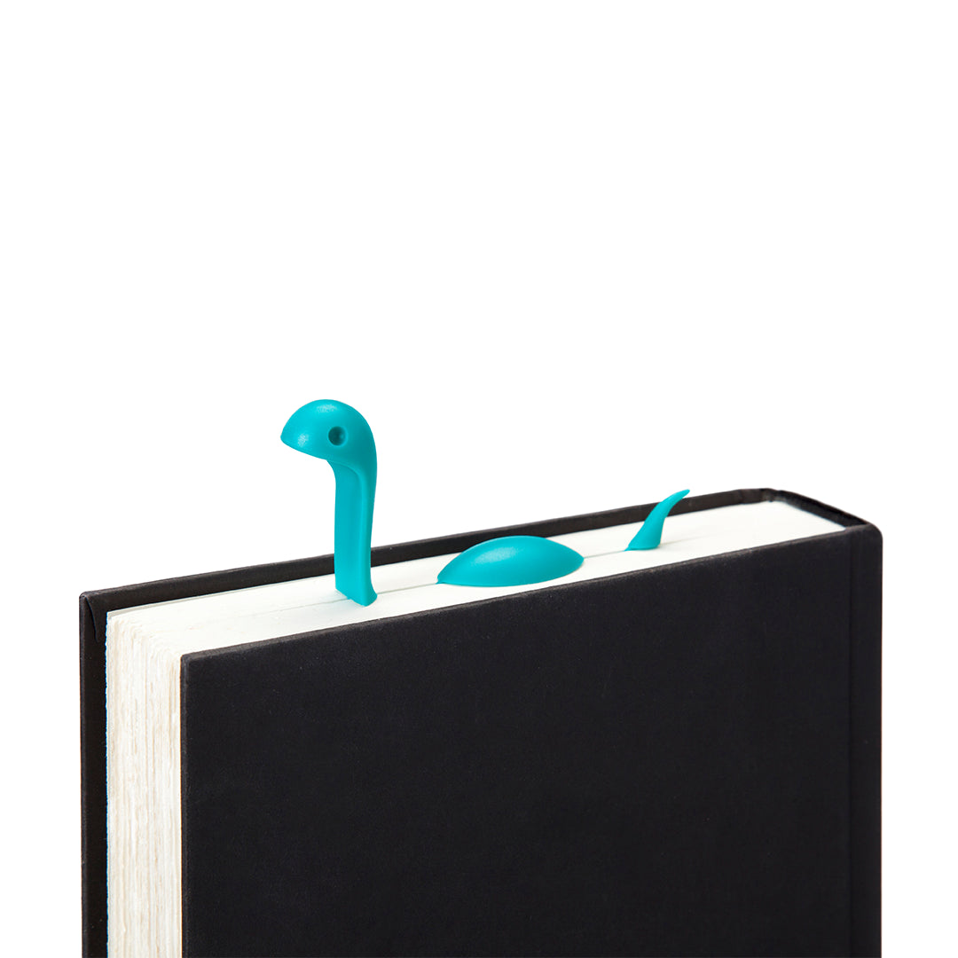 Nessie Tale peeks from a closed book, adding whimsy to your reading session.
