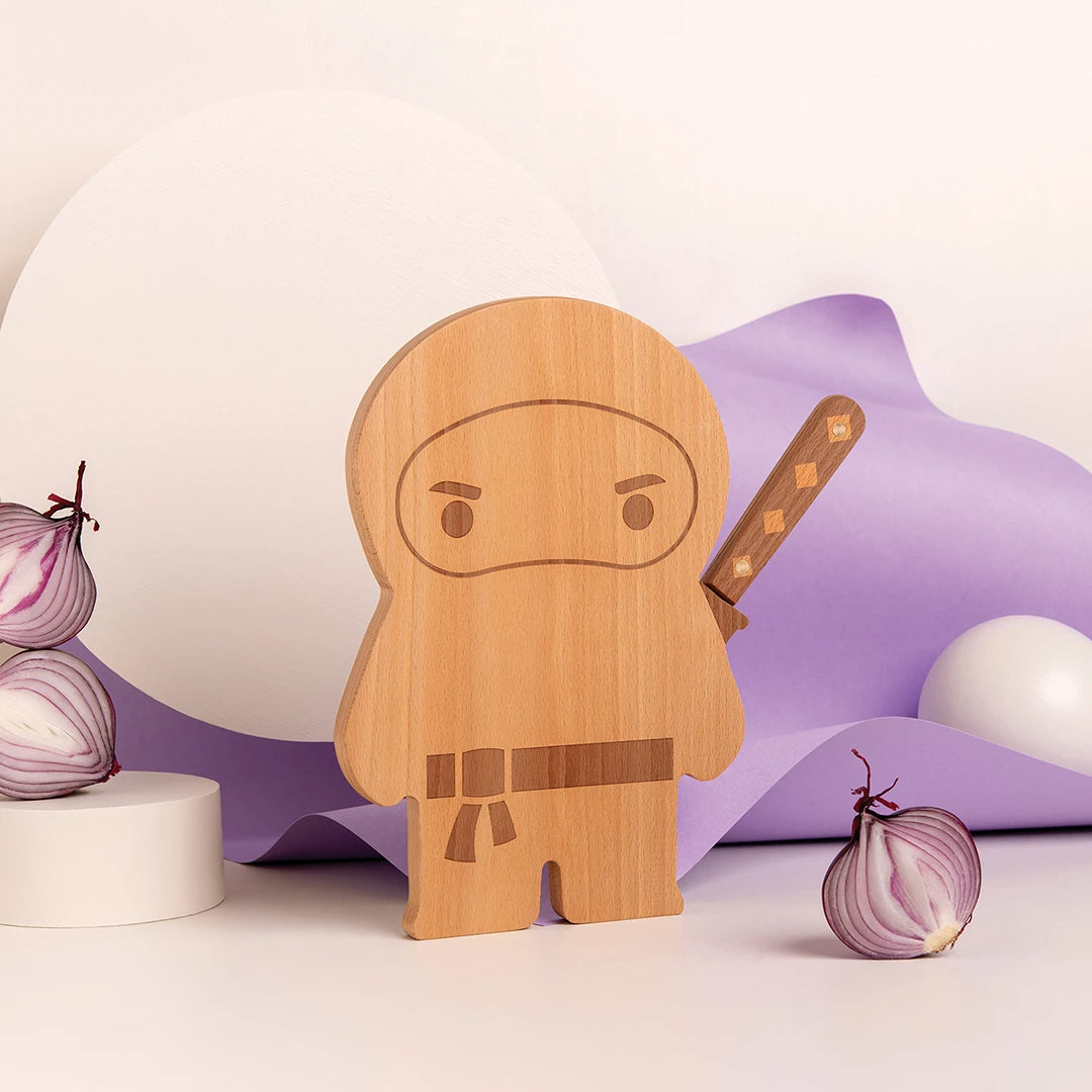 Ninja Board with wooden ninja figure, sword, halved red onions, and abstract shapes.