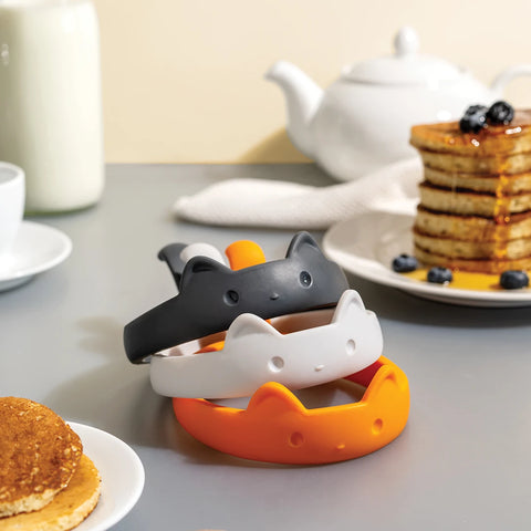 PanCats pancake molds and egg rings on a kitchen table.