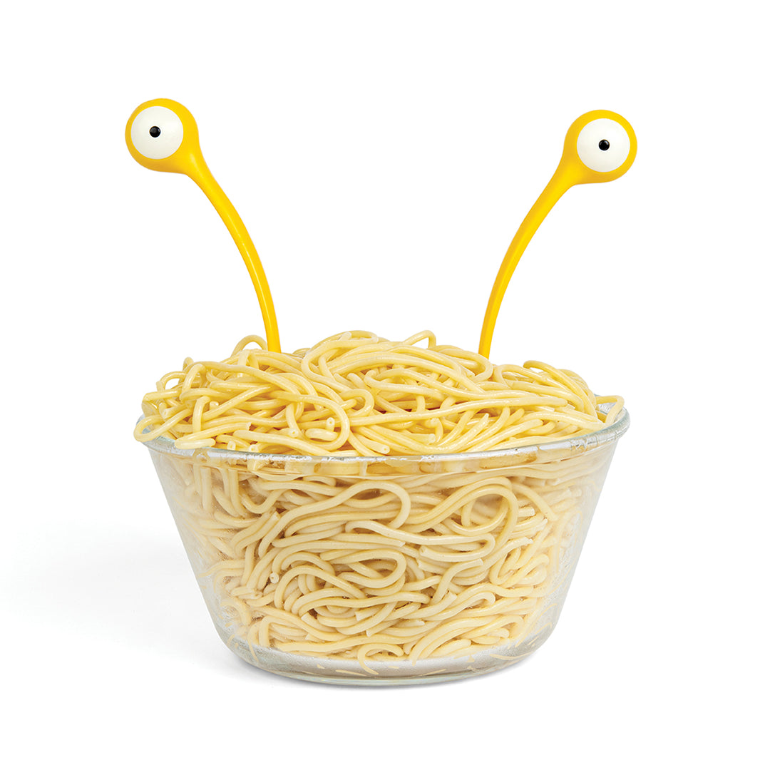 A bowl of spaghetti with Pasta Monsters peeping out like eyeballs.