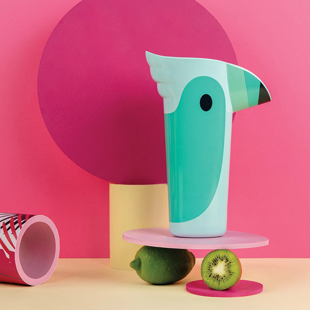 A Polly pitcher featuring fruit on a vibrant pink backdrop.