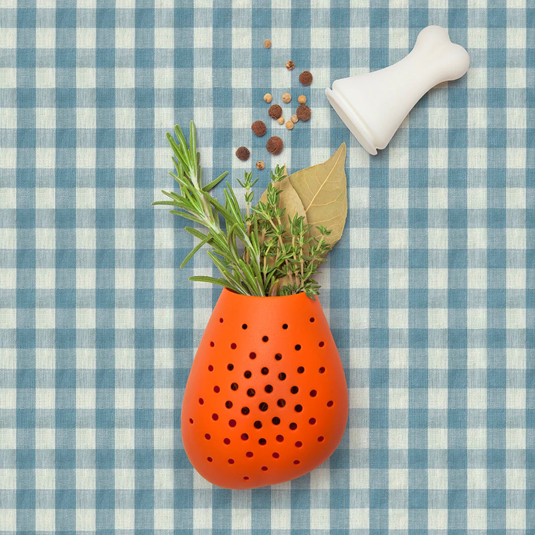 Pulke herb infuser with lid on a blue checkered background.