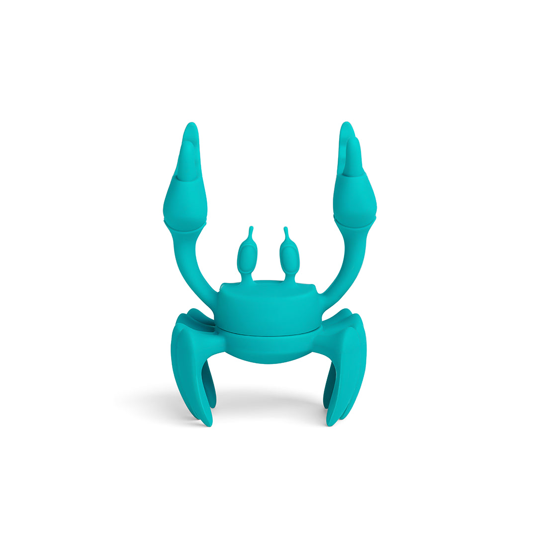 Aqua crab-shaped phone holder by Dor Carmon, with adjustable claws and legs on a white background.