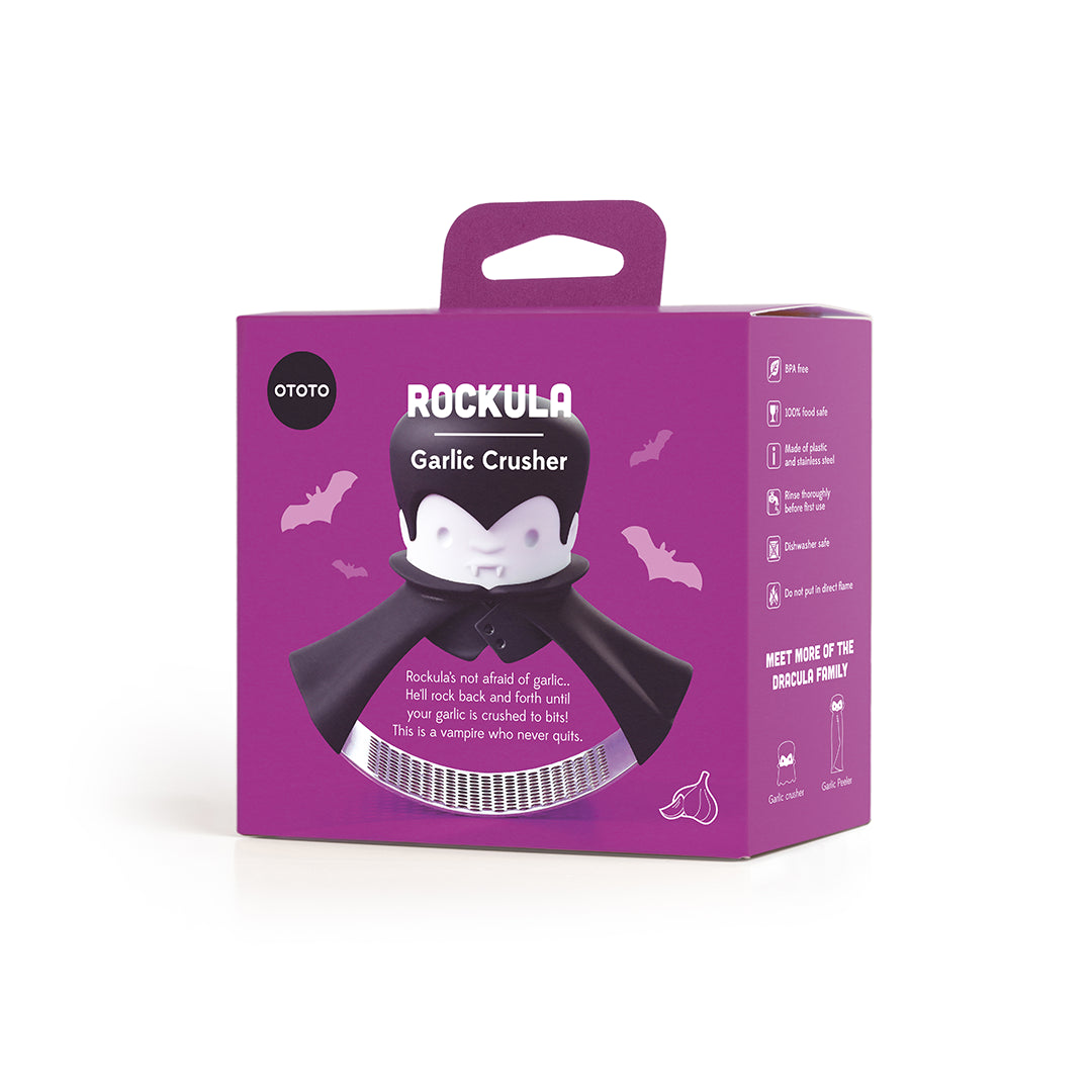 Purple packaging of the Rockula, a garlic crusher with vampire magic and a cartoon design.