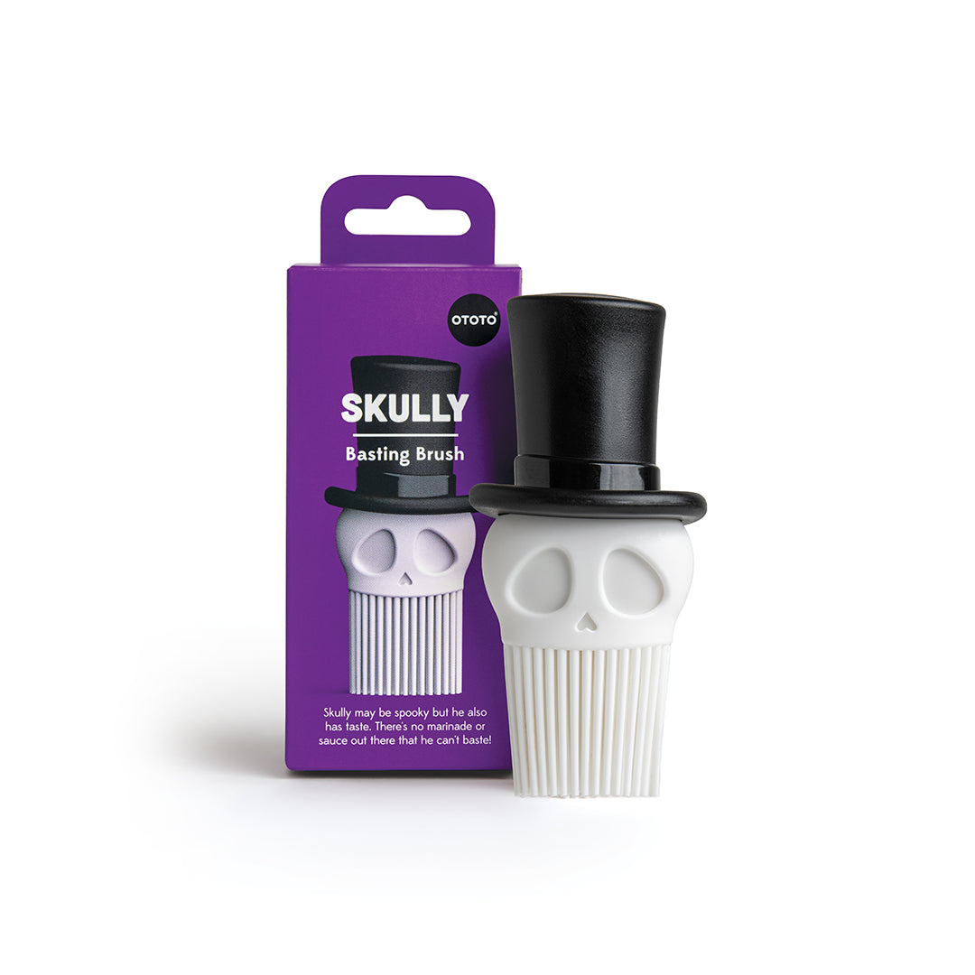 Skully: A skull-shaped basting brush with a black top hat, perfect for cooking; comes in purple packaging.