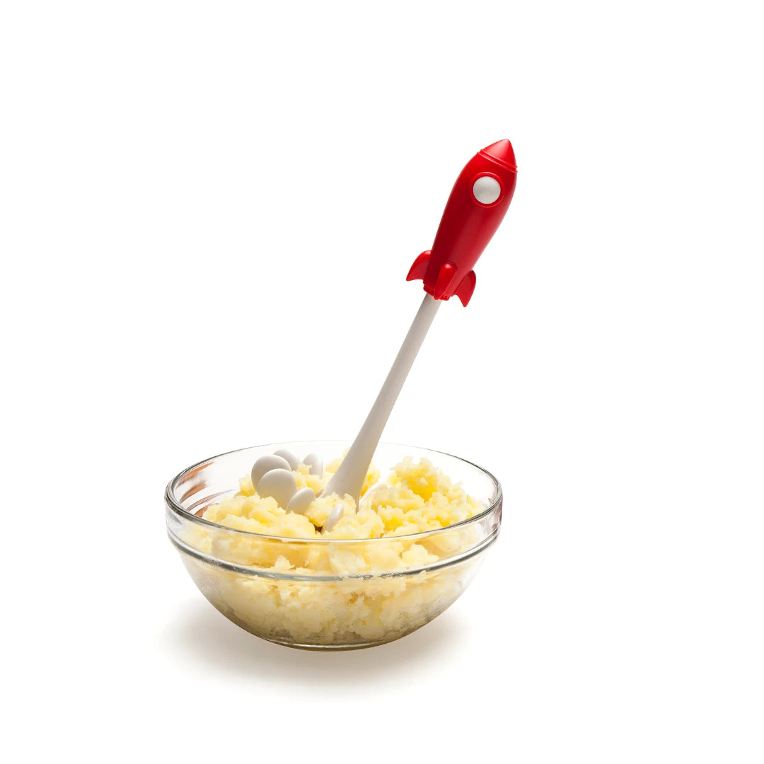 A bowl of mashed potatoes with a Space Masher on a white background.