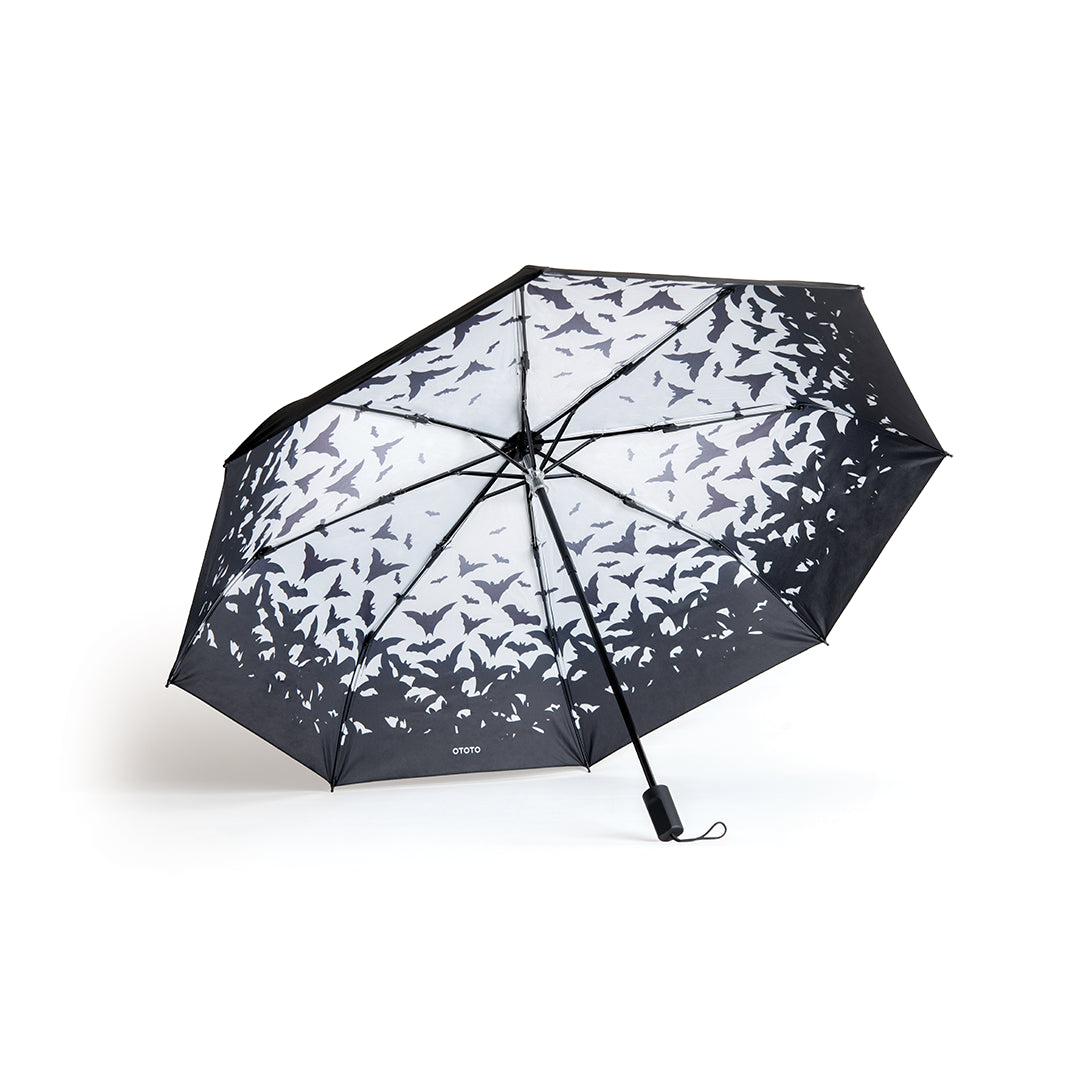 The Spookula umbrella showcases flying bats on its inner canopy, set open against a white background.