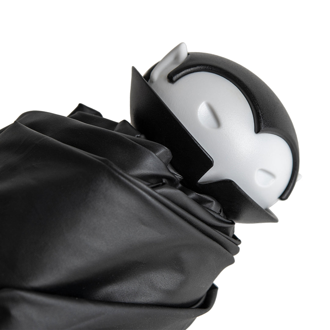 Spookula: A black-and-white vampire figure with closed eyes, wrapped in black cloth.