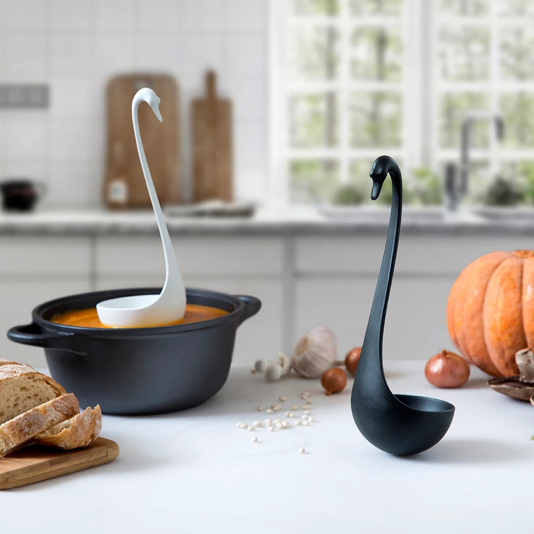 Swanky swan ladles elegantly float through soup, bread, and veggies in chic black and white designs.