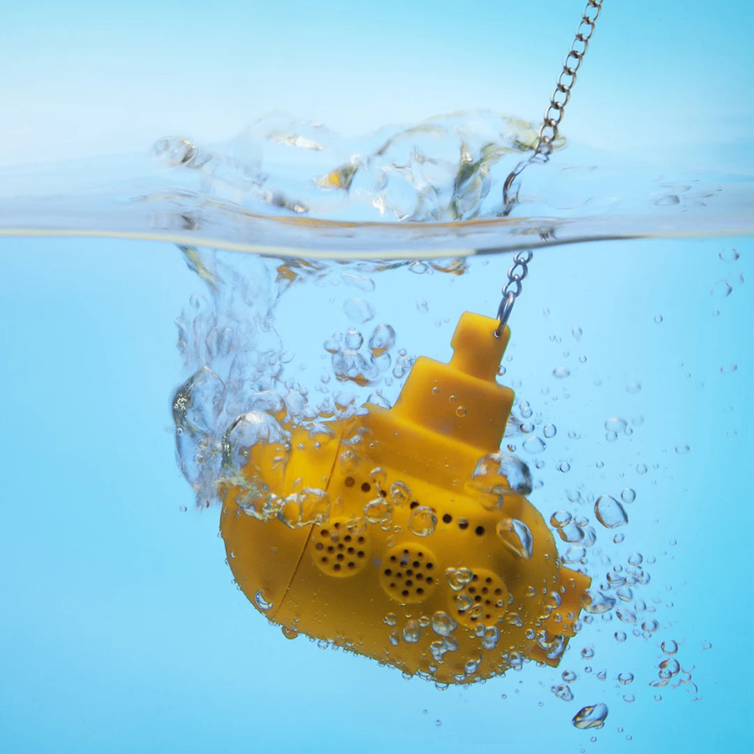 Yellow Tea Sub infuser in water with bubbles, set against a blue background.