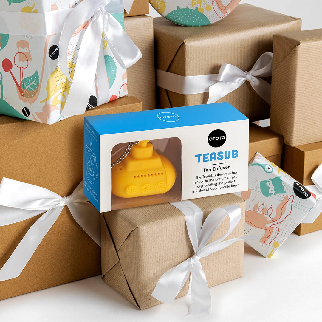 Tea Sub surrounded by wrapped gifts with white ribbons and colorful patterns.