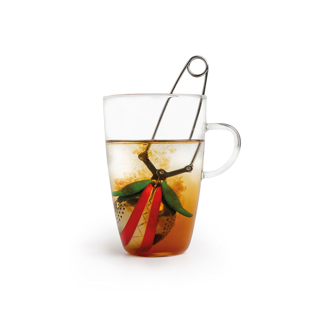 Transparent mug with the Tea Trap by OTOTO inside, steeping and swirling the fragrant brew.