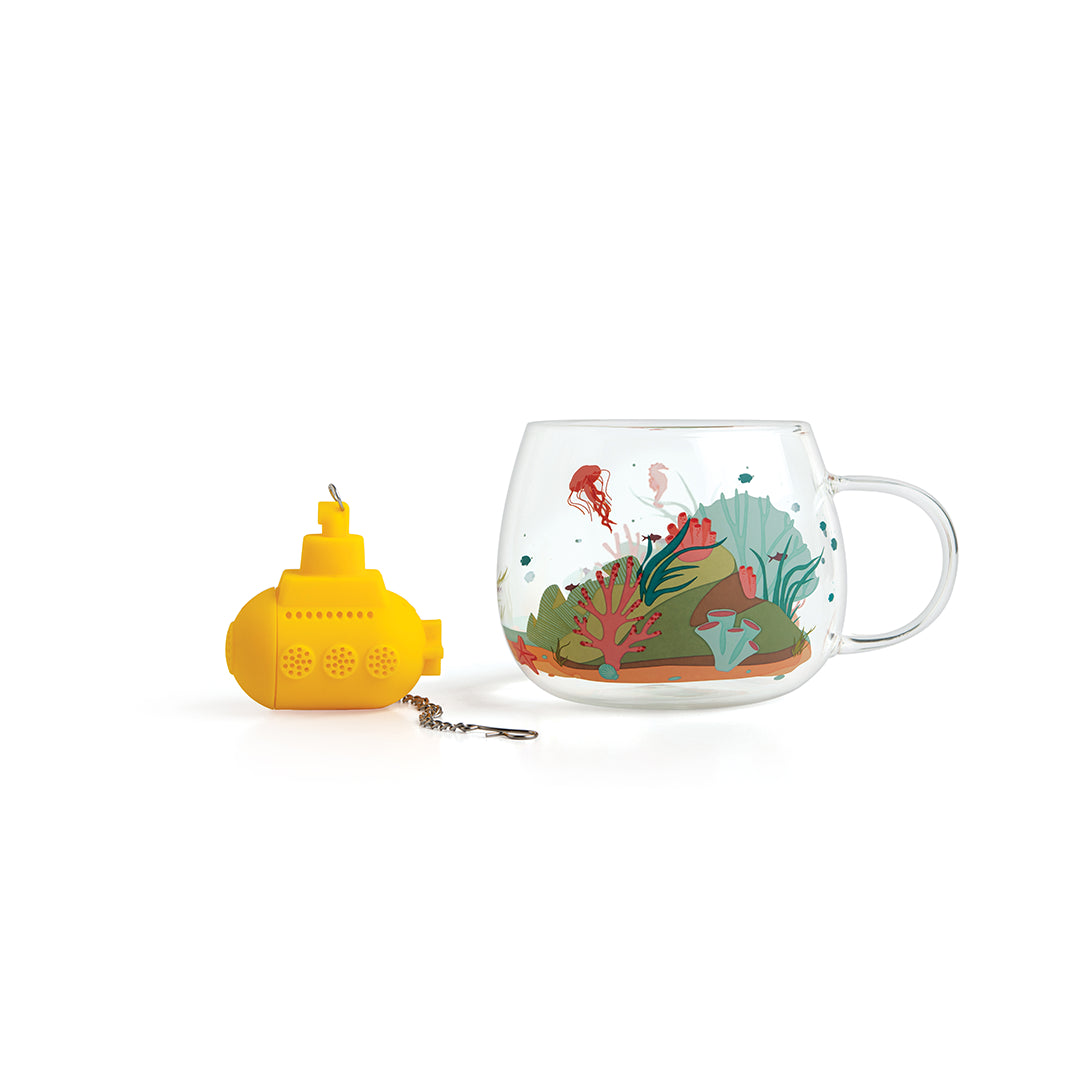 Under the Tea: A glass cup with ocean design and a yellow submarine-shaped tea diffuser.