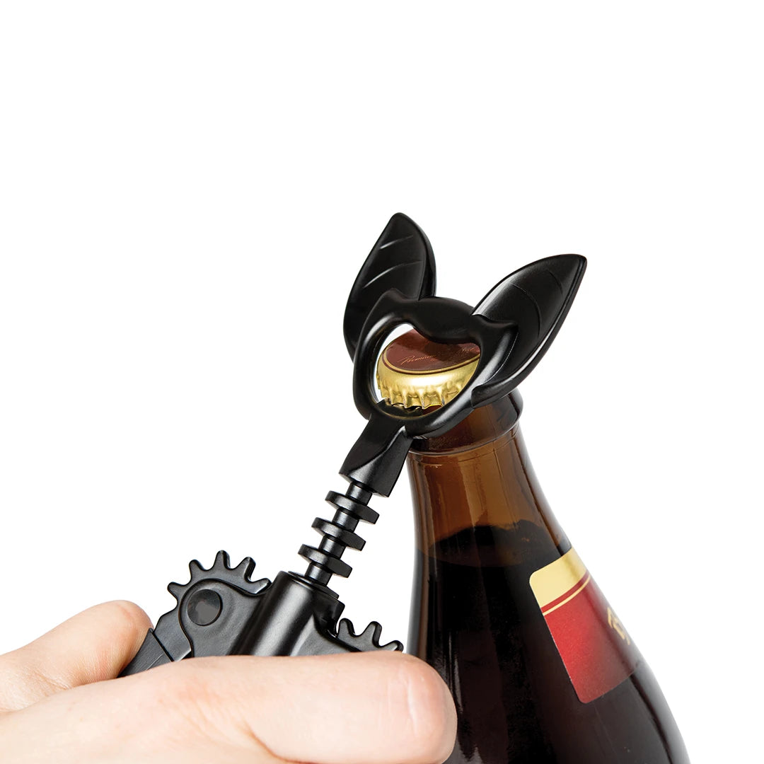 OTOTOs Vino bat-shaped bottle opener effortlessly uncaps a brown glass bottle.