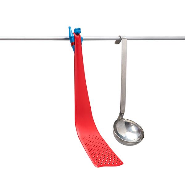 Pan Man - Superhero Spatula & metal ladle hang alongside a red plastic strainer on a white background.