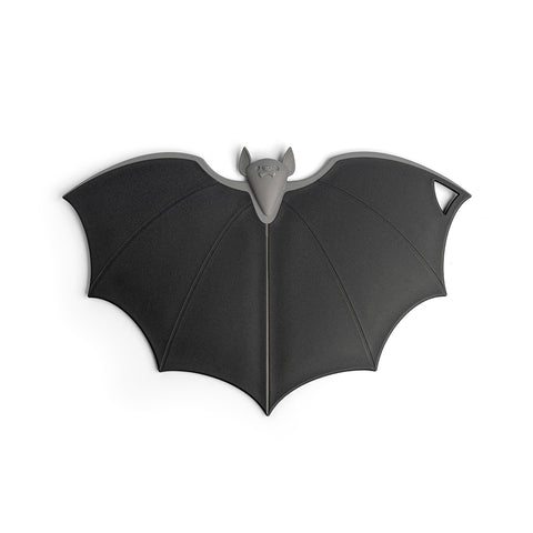 Batty trivet by OTOTO, bat-shaped in dark gray with a hole and folding wings at one wings tip.
