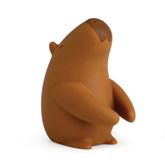 A brown OTOTO Capybrush capybara toothbrush holder gazes upward against a white background.