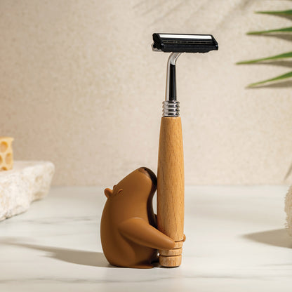 OTOTO’s Capybrush holds a wooden-handled razor on a light countertop.