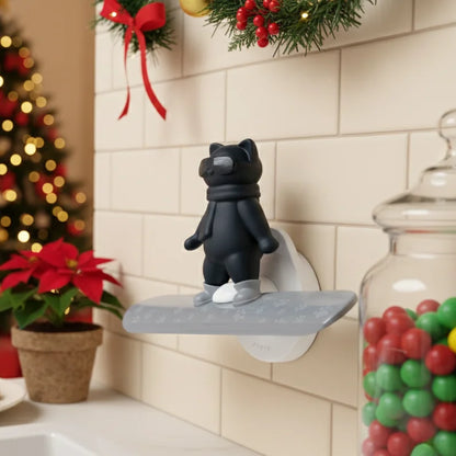 Chill Cat OTOTO figurine on a wall shelf with holiday decor, candies, and poinsettia.