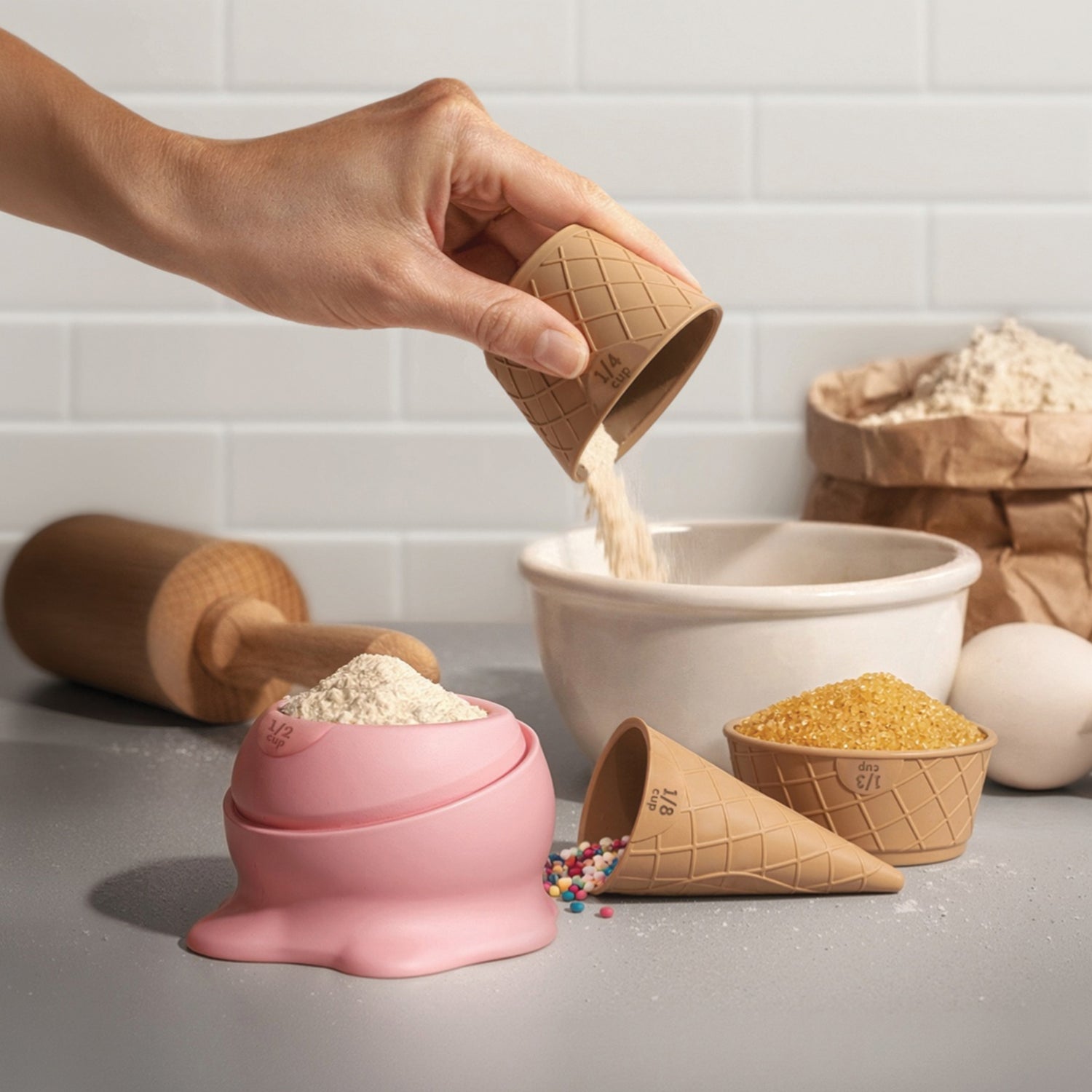 Flour is poured from a Coney measuring cup into a bowl, perfect for baking cookies.